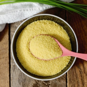 overhead shot of raw couscous in a black bowl