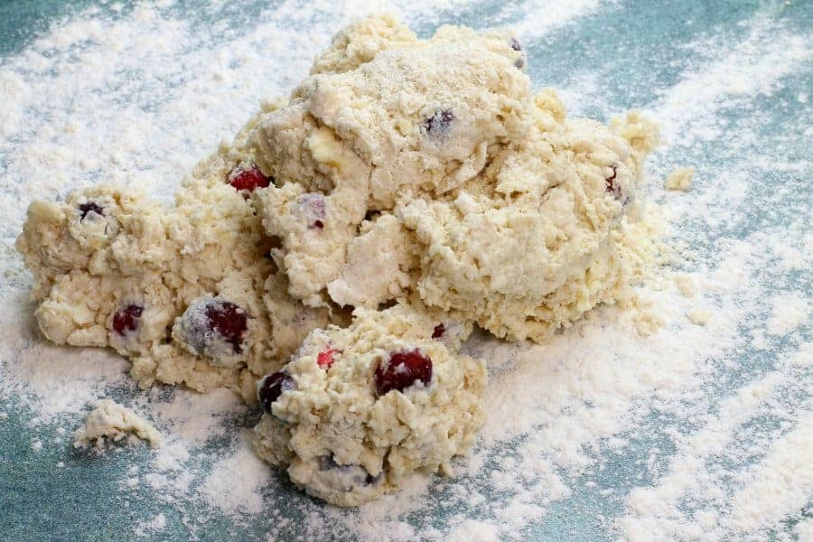 a example of the slightly wet and sticky cranberry scone dough after mixing in the milk, laying on a floured counter. 