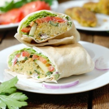 freshly made falafel wrap cut and stacked on a white plate