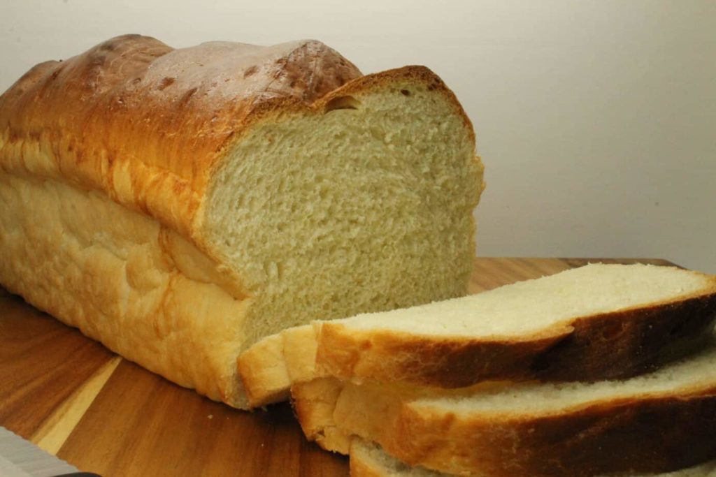 A freshly sliced loaf of homemade sandwich bread