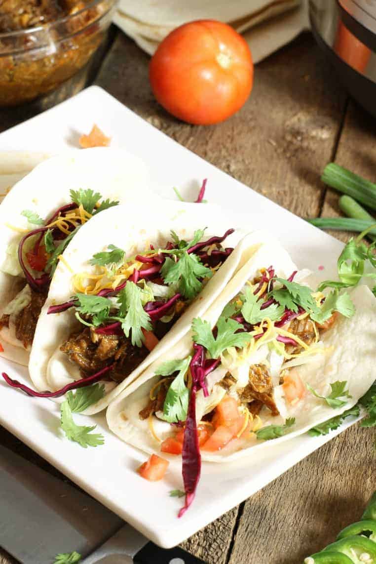 instant pot pulled pork tacos on a white plate