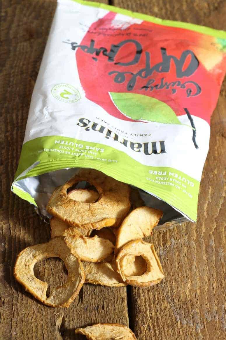 A snack sized bag of martins family apple chips on a wooden table