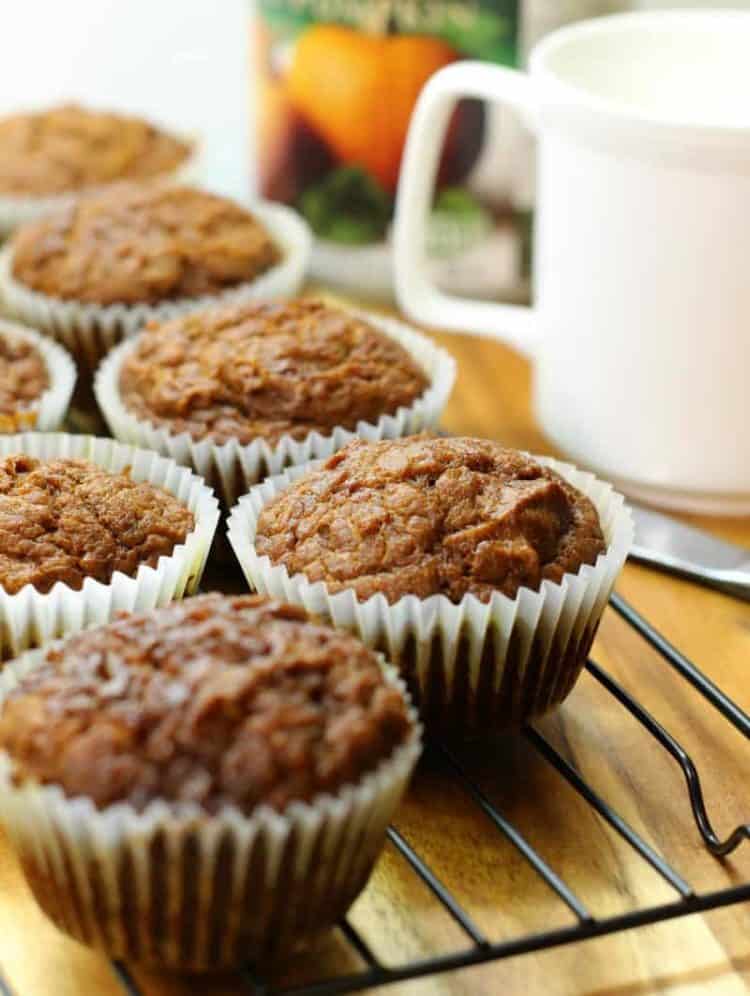 Pumpkin breakfast muffins cooling on a black wire rack