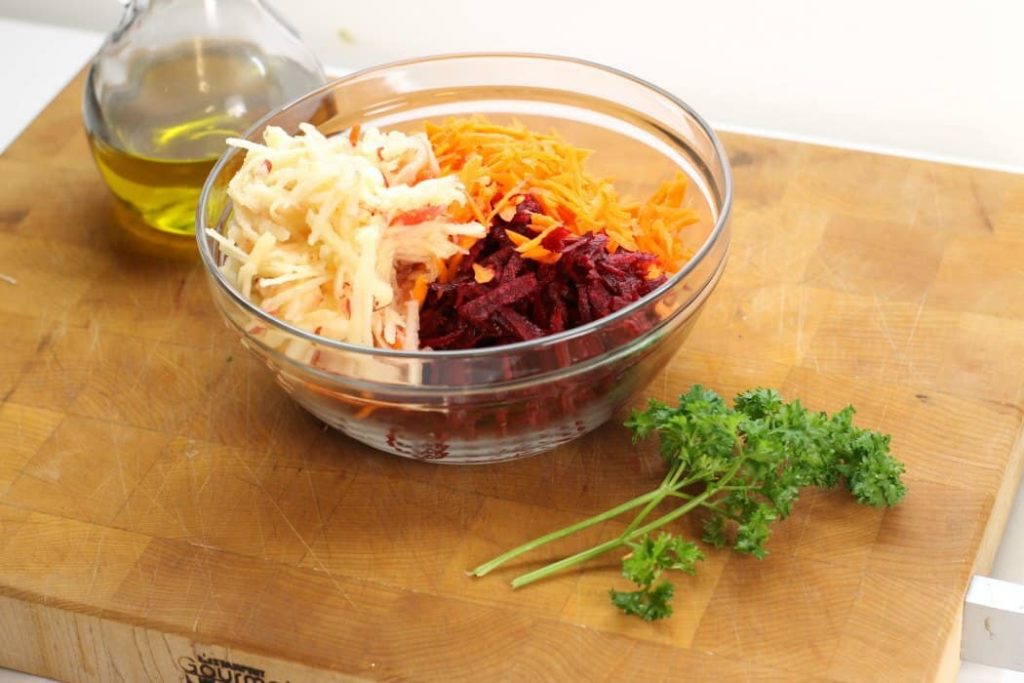 shredded beets, shredded carrots, and shredded apples in a bowl