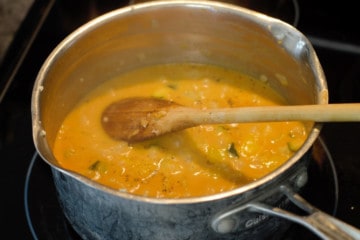 chickpea curry simmering in a pot on the stove