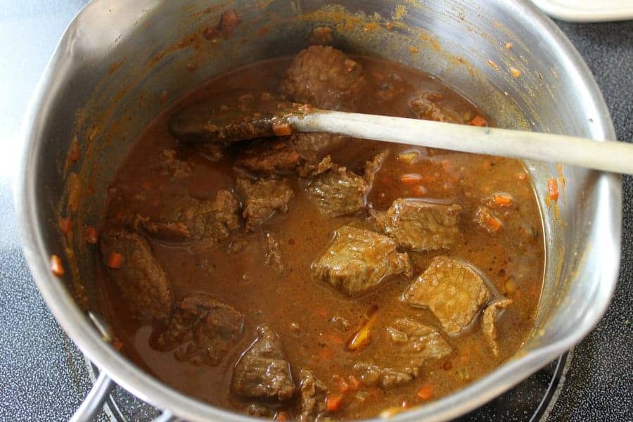 Stewed German goulash in a stainless steel pot.