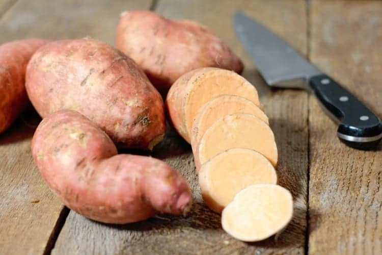 orange sweet potato whole, and sliced on display