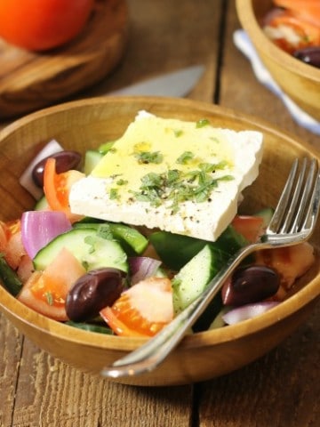 traditional greek salad known in greece as horiatiki, served in a rustic wooden bowl